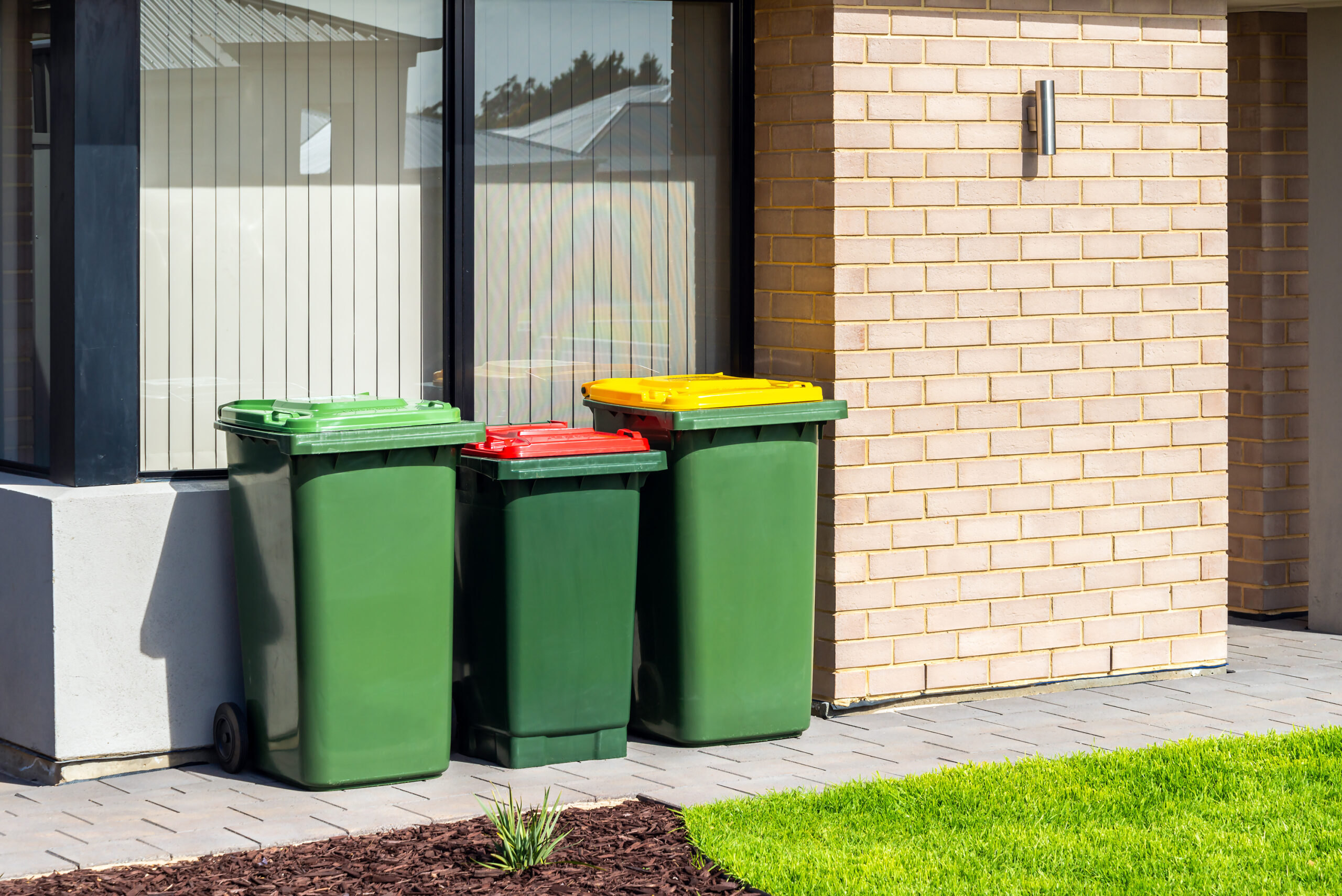 Australian home garbage bins on front yard